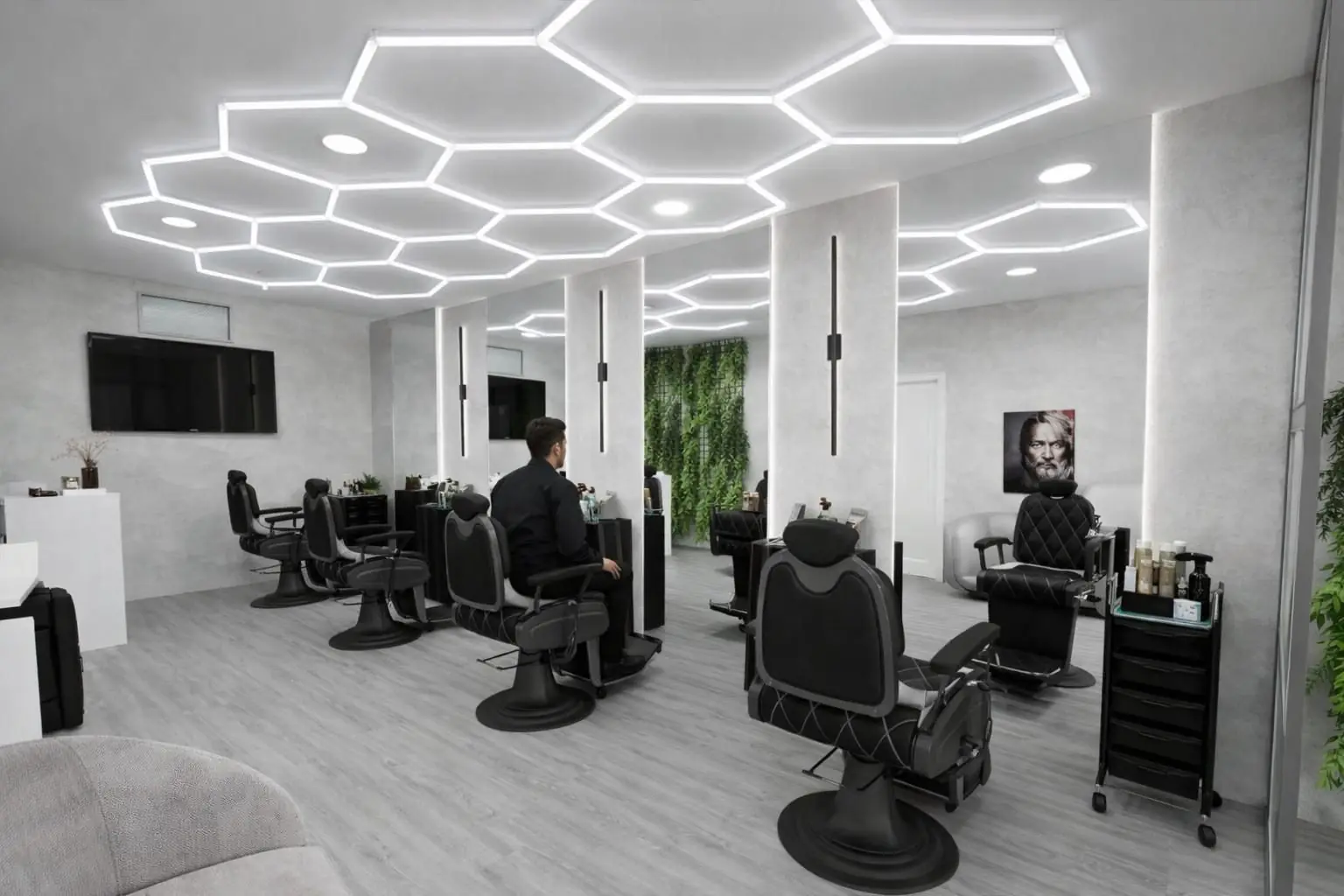 A barbearia Félix: cadeiras em pele preta sob uma iluminação em favo de mel